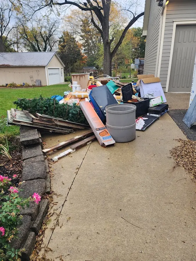 Dumpster being loaded with debris for 12 Yard Dumpster Rental in Oviedo